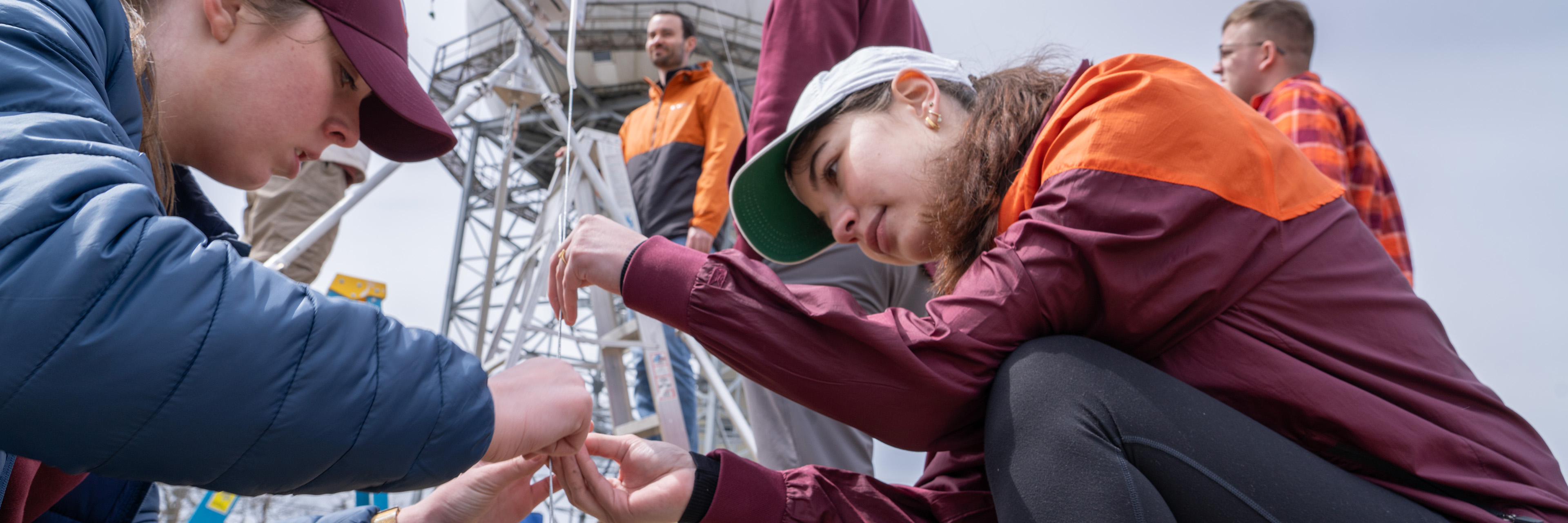 Students installing a weather station on top of a mountain