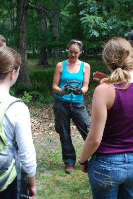 Graduate student Dana Morin shows students how to operate a coyote foot-hold trap.
