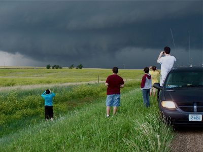 The storm chase crew soon learns that it needs to be ready for anything. Minutes after the photo above was taken on a rural roadside in the Oklahoma Panhandle, the storm produced a large tornado wrapped in rain.