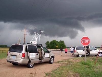 Instructor Dave Carroll developed a custom set of masonets for recording storm data. These portable weather stations easily attached to the top of the storm chase vans and record data on a laptop computer. Here, the masonet probe samples atmospheric conditions near a supercell thunderstom in western Kansas as the crew observes a rotating wall cloud associated with the storm.
