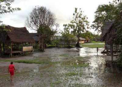 As the floodwaters recede, villagers venture out on foot.