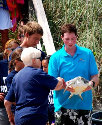 Jean Beasley directs the Aqua Kids during the sea turtle release on Topsail Beach.