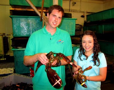 Clark and a fellow “Aqua Kids” cast member learn about lobster at the Trenton Bridger Lobster Pound in Maine.