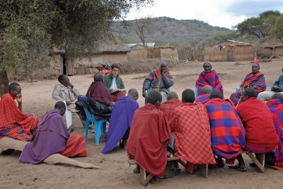 Tim Baird interviews Maasai men about social networks and traditional gift giving. Photo by Kiyah Duffey