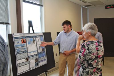Wildlife conservation major Alex Grimaudo discusses his work on incubation behavior in wood ducks at the Saturday poster session.