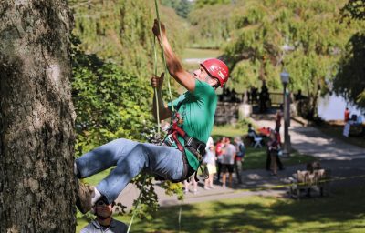 Alumnus Arthur Egolf (’90 B.S., ’92 M.S. forestry) tries his hand at tree climbing at the Share Fair.