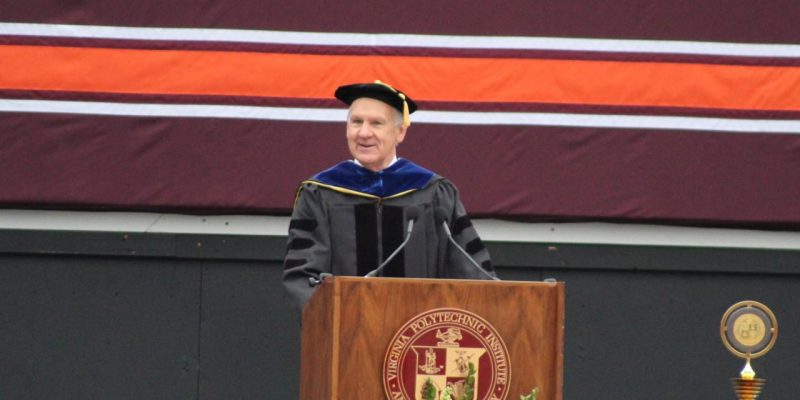 Dean Paul M. Winistorfer standing in front of a podium with the Virginia Polytechnic Institute and State University seal delivering a commencement speech.
