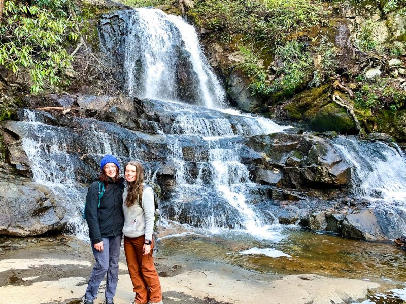 Graduate students Mary Grace Larson (left) and Maia Caddle hiked to a waterfall in the Great Smoky Mountains National Park as part of their research about programs offered by the National Park Service.